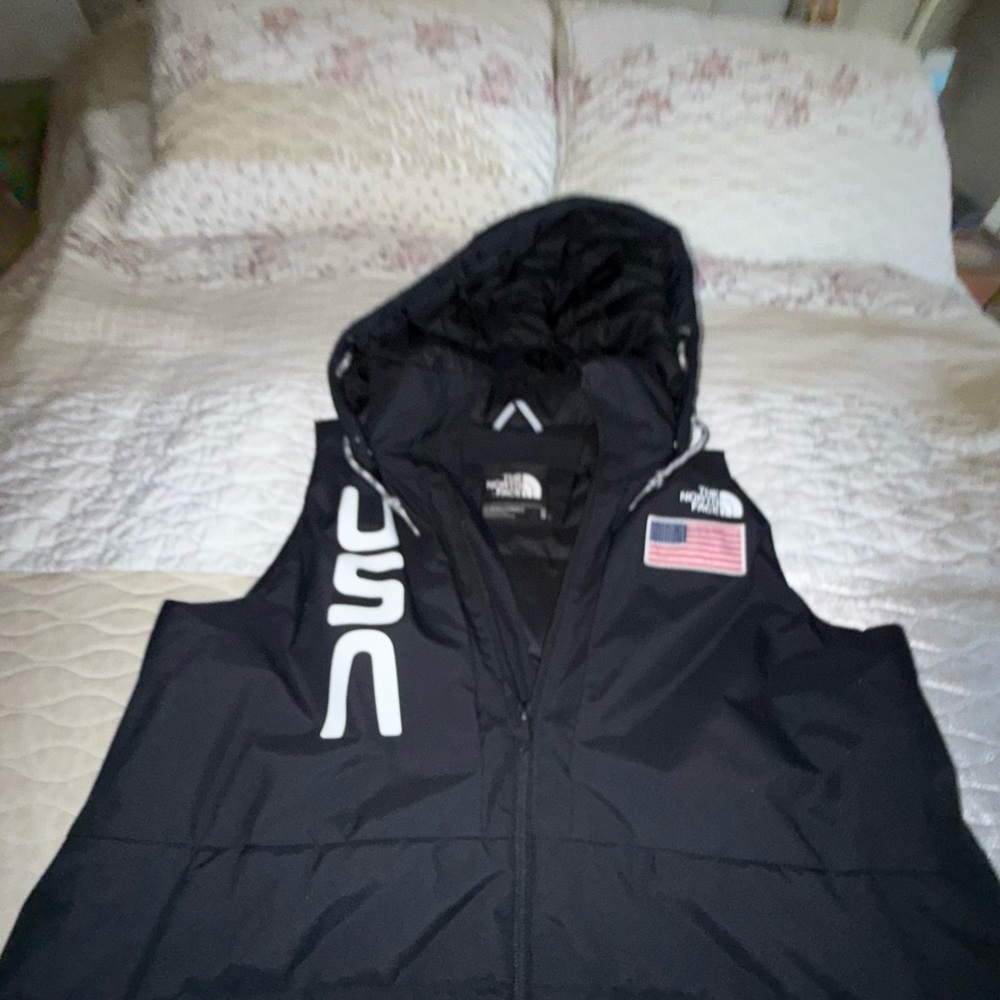 The North Face Black Hooded Vest with USA Logo.